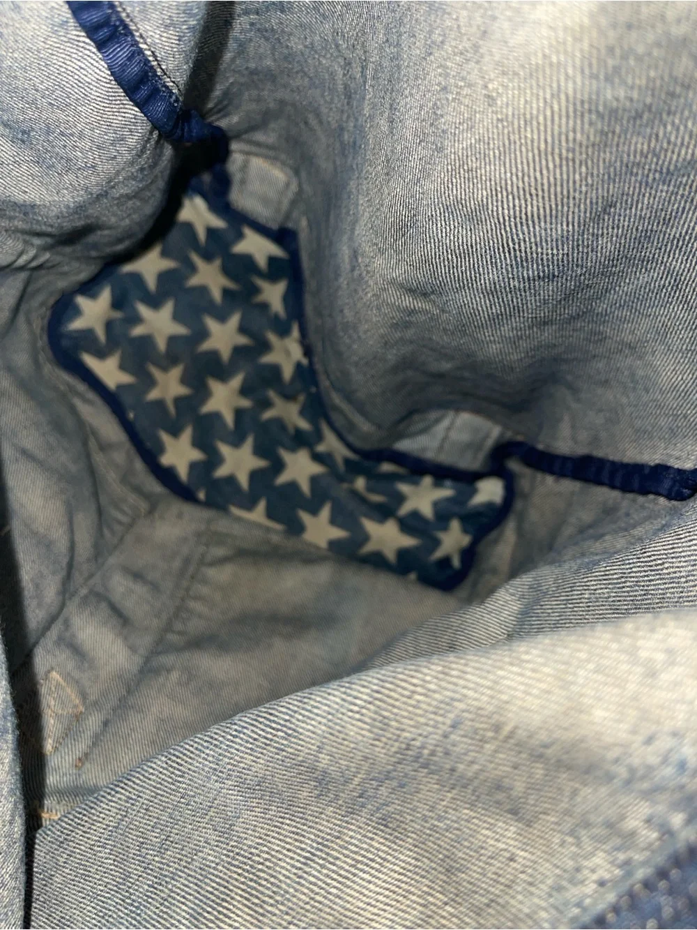 Hysteric Glamour denim backpack with white stars and repeating text graphics